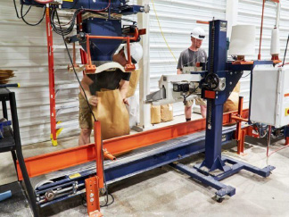Students operate the automated bagging system inside the Feed Technology Center at the University of Illinois.